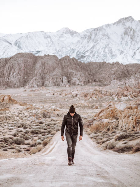 istock man standing at Alabama Hills 1212351619