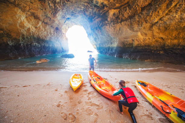 istock Father and son together paddling in kayak 1212351713