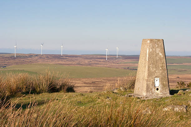Triangulation Point With Windfarm Backdrop stock photo