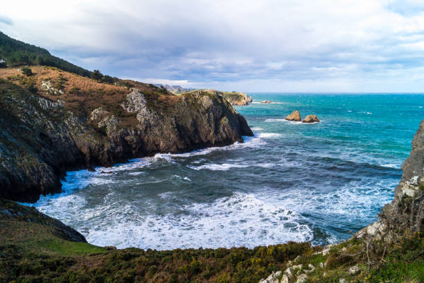 istock Mountains next to cove with cliffs on cloudy day with wind, Punt 1212354803