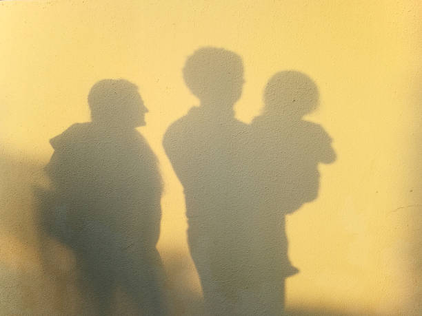 istock Young family shadow on the wall 1212354854