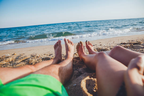 istock Couple relaxing on the beach 1212356016