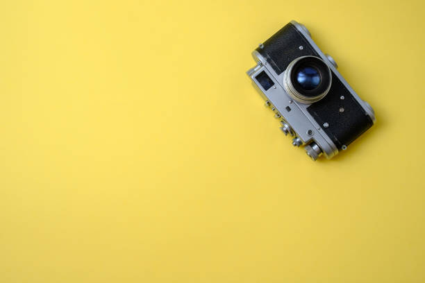 istock old vintage retro camera on a yellow background 1212356758