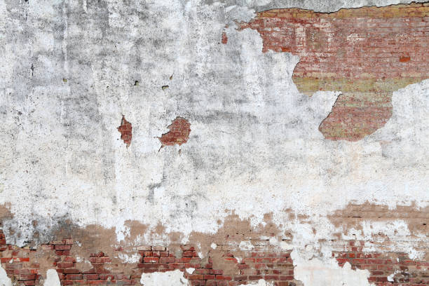 istock faded white cracked stucco red brick garden wall 1212358751