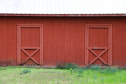 A red garden shed rests in a grassy field in central Vermont on a mid October afternoon.