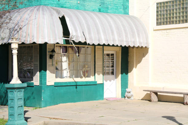 abandoned green store building awnings glass brick window shadows
