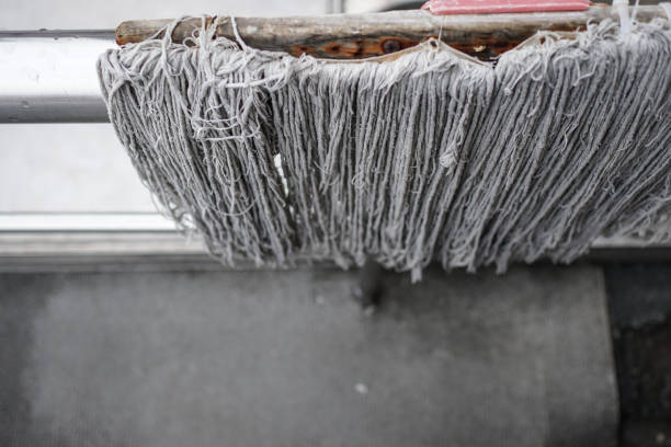 istock Close up on mop outdoors. Place on a metal railing to dry. 1212359384