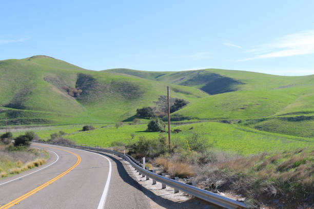 istock winding curved road bright mountain hillside blue sky 1212359438