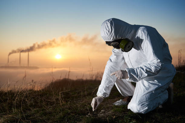 scientist taking sample of ground at thermal power station. - toxic substance dirt pollution scientific experiment imagens e fotografias de stock