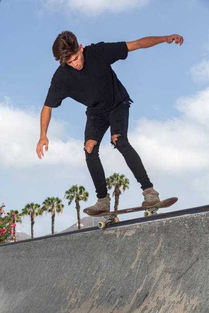 istock Young skateboarder performing tricks in a park. 1212363446