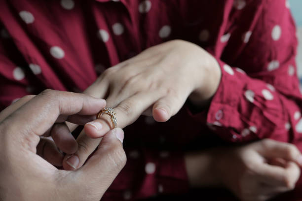 istock diamond wedding ring in hand, close up 1212366971