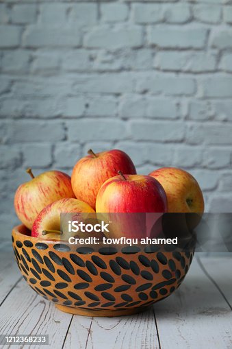 istock fresh red apple with wooden bowl, close sup 1212368233