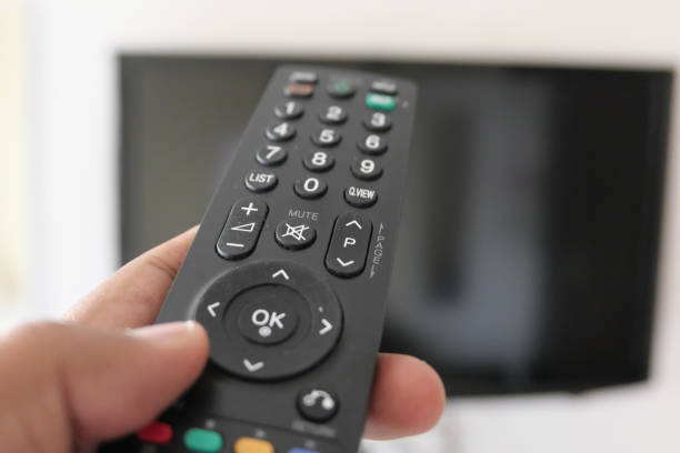 istock Close up of man hand use Tv remote 1212368892