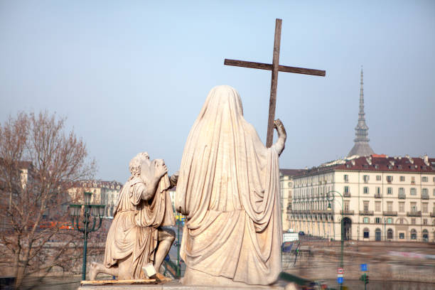 istock statue with cross in Turin 1212370315