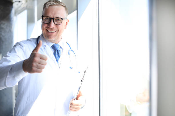 istock Senior chief physician in white robe with stethoscope. 1212371832