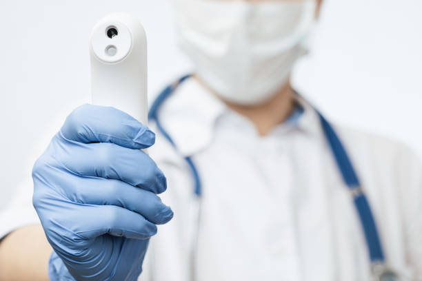 istock Doctor pointing infrared thermometer gun to check body temperature epidemic virus outbreak concept 1212374805