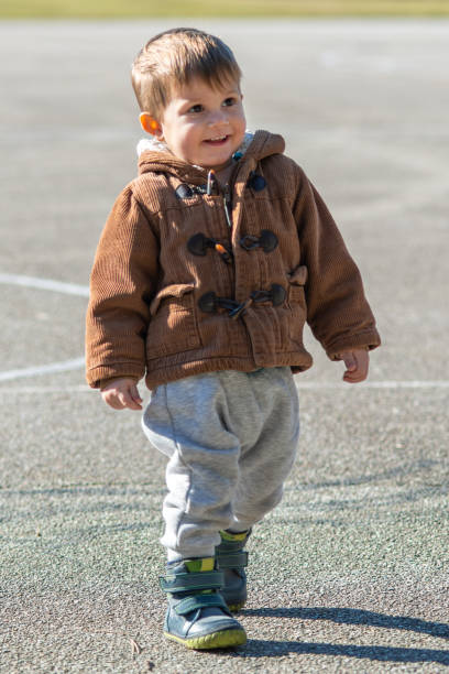 istock A little boy is walking on a sports field 1212374991