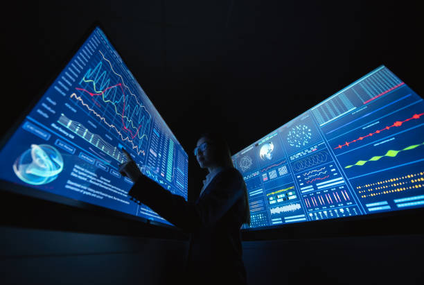 istock The business lady standing between blue screens in the dark laboratory 1212374996