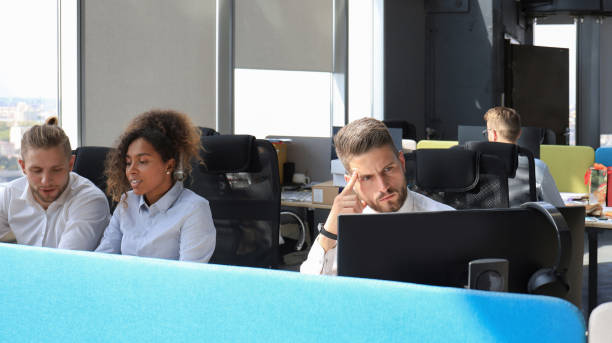 istock Group of young modern people in formalwear using modern technologies while working in the creative office 1212377000