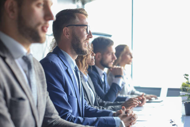 istock Image of row of business people working at seminar. 1212378099