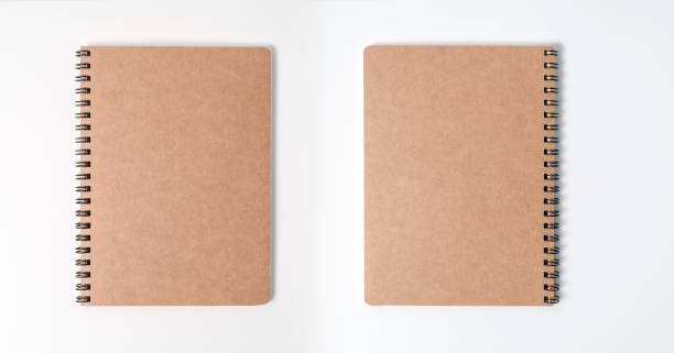 istock Brown spiral notebook isolated on white background.top view 1212379353