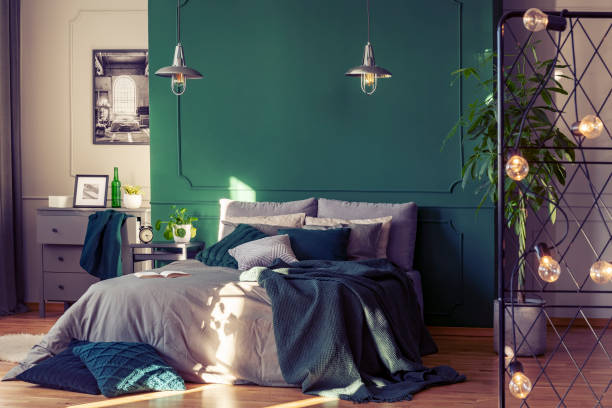 istock Copy space on empty green wall of elegant bedroom interior 1212379440