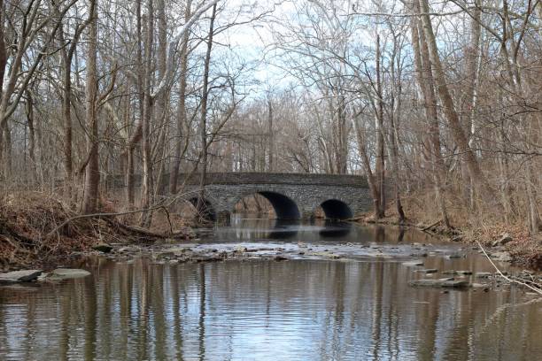 istock Old Stone Bridge and Flowing Creek 1212380218