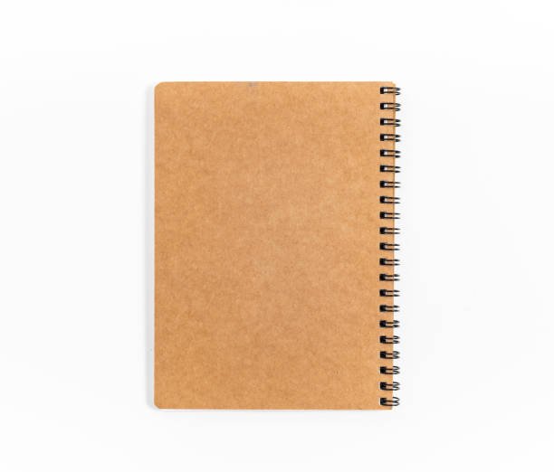 istock Brown spiral notebook isolated on white background.top view 1212380270