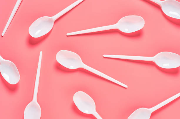 istock White disposable spoons scattered on pink background. Concept of save environment, ecology, recreation on picnic, party and other events. Top view 1212380416