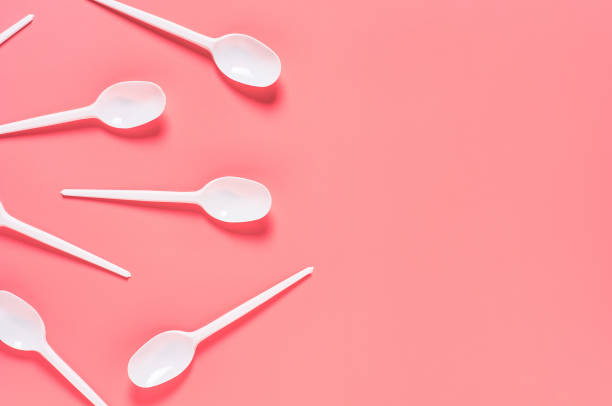 istock White disposable spoons scattered on pink background. Concept of save environment, ecology, recreation on picnic, party and other events. Copy space. Top view 1212380423