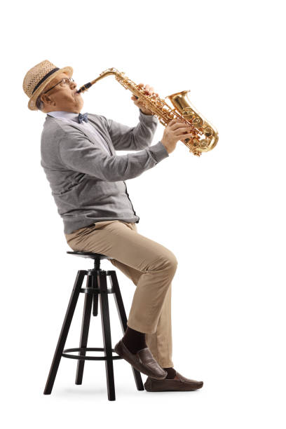 istock Elderly man sitting and playing a saxophone 1212380937