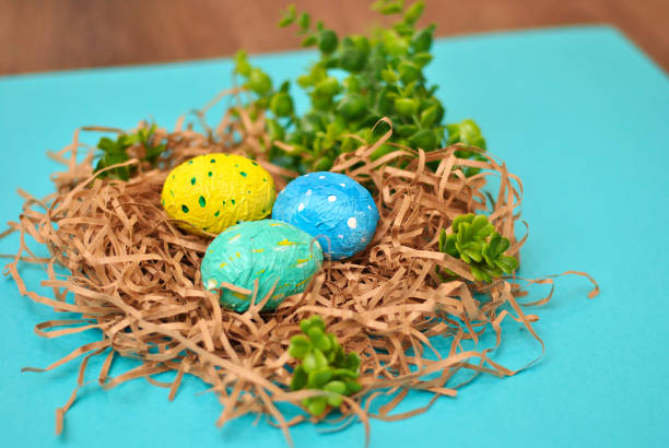 istock Spring Easter colorful painted blue yellow and green eggs on the blue background flat lay closeup top view beautiful picture. Congratulations card happy holiday 1212383239