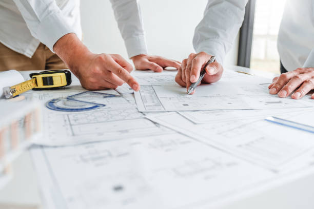 istock Team Engineer drawing graphic planning and meeting for architectural project on workplace 1212383392
