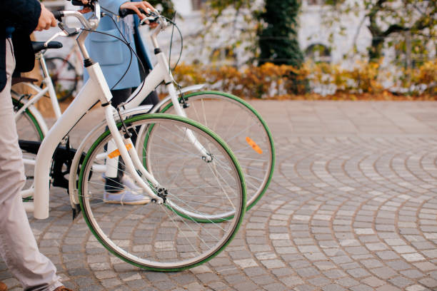 istock Happy Couple Pushing Bicycles In Autumn 1212384319