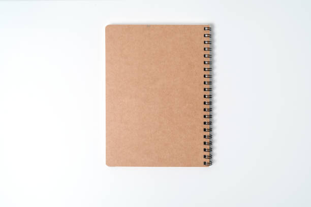 istock Brown spiral notebook isolated on white background.top view 1212384966