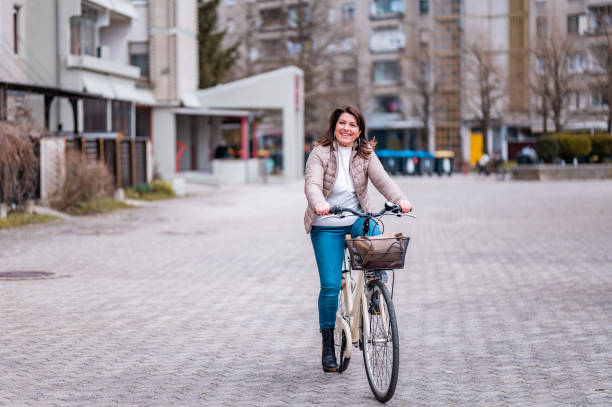 istock Woman riding a bicycle in a residential district 1212385133