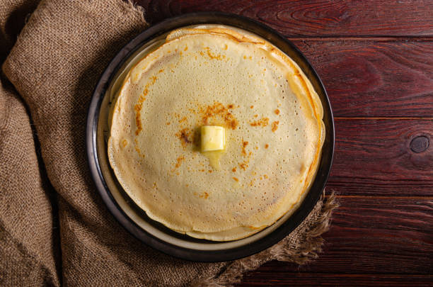 istock Traditional Russian homemade pancakes on a large round plate in a rustic style. 1212385849