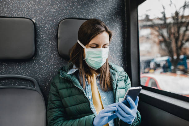 istock Woman with protection mask in a bus 1212385923