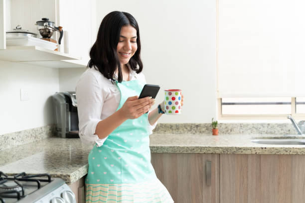 istock Attractive Young Woman Taking A Break From Cooking 1212386054