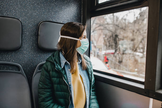 istock Woman with protection mask in a bus 1212386087