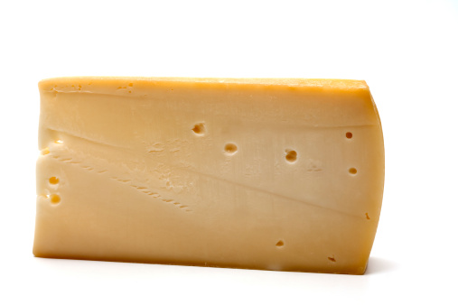 Studio shot of Morbier cheese cut out against a white background.