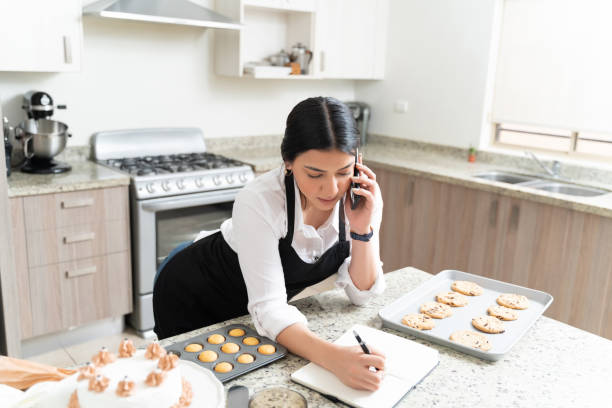 istock Beautiful Young Entrepreneur Noting Order At Home 1212387110