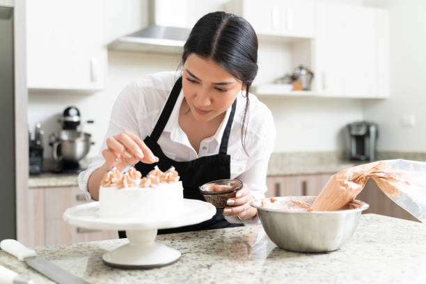 istock Gorgeous Female Pastry Chef Making Cake 1212387202