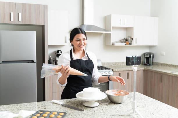 istock Happy Caucasian Video Blogger Preparing Cake At Home 1212387295