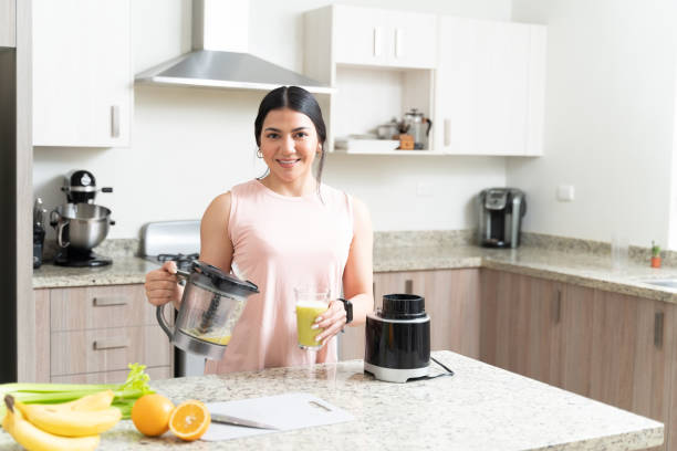 istock Beautiful Woman Standing With Fresh Juice 1212387390