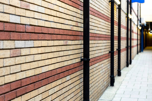 istock Red and beige painted brick wall for background. View in depth. Selective focus. 1212390539