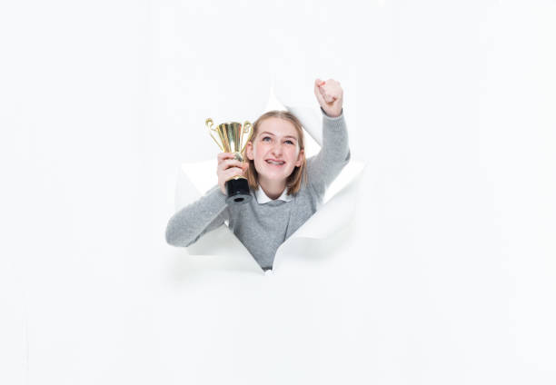 generation z female junior high student in front of white background wearing jeans and holding trophy - thank you excitement waist up horizontal imagens e fotografias de stock