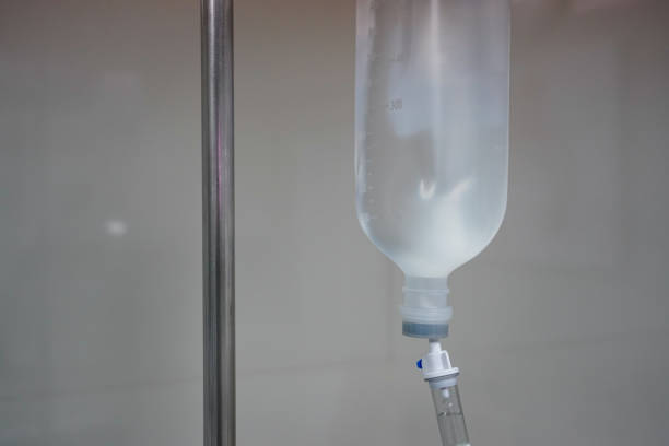 istock Close up Infusion bottle pump with saline solution drip and clipping path for patient admit room in hospital. 1212392691