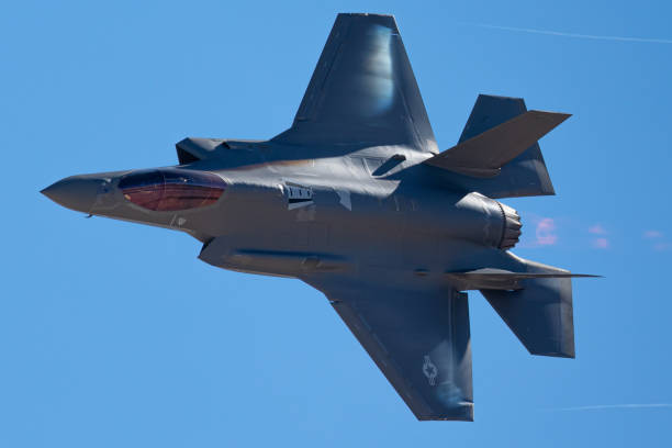 istock F-35 Lightning II  approaching  with afterburner on and condensation trails at the wing 1212394082