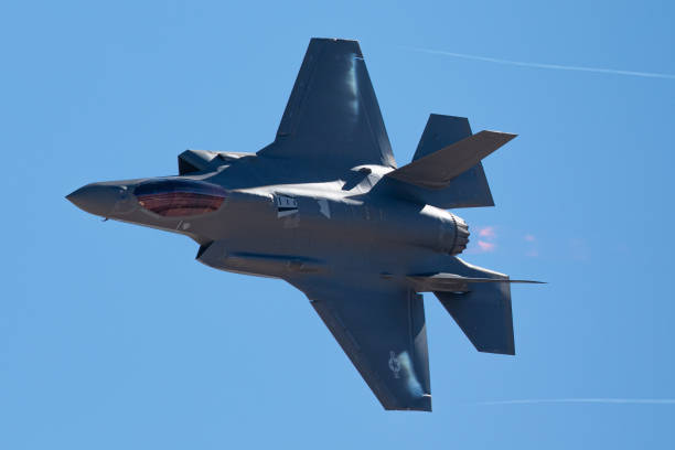 istock F-35 Lightning II  approaching  with afterburner on and condensation trails at the wing 1212394102